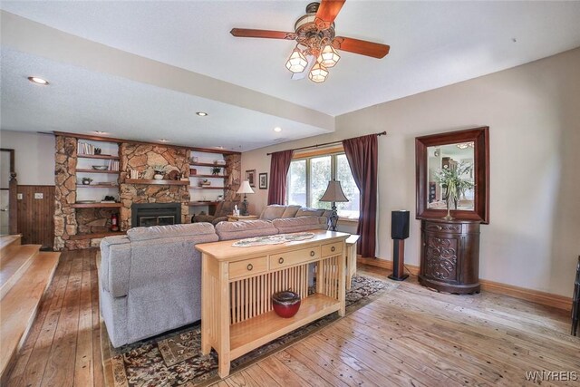 265 Miller Rd, Amherst, NY 14068 - living room with hardwood / wood-style floors, a ceiling fan, a stone fireplace, recessed lighting, and stairway