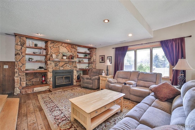 265 Miller Rd, Amherst, NY 14068 - living room featuring a textured ceiling, wood-type flooring, a fireplace, and recessed lighting