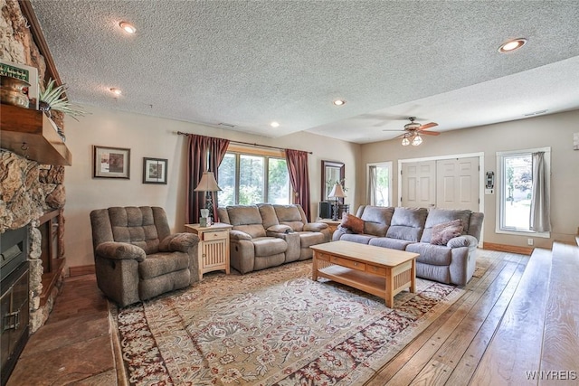 265 Miller Rd, Amherst, NY 14068 - living area with a textured ceiling, a fireplace, a ceiling fan, recessed lighting, and hardwood / wood-style flooring