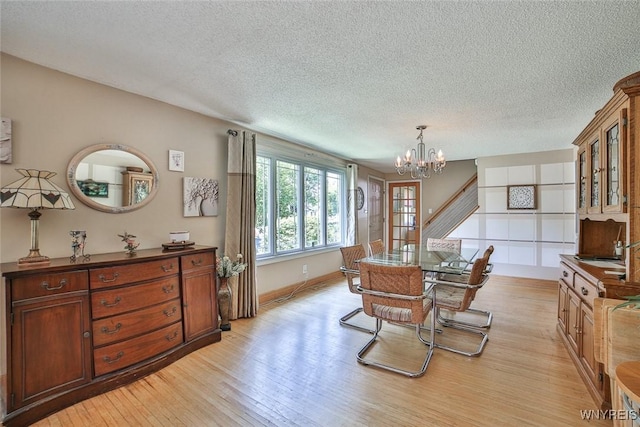 265 Miller Rd, Amherst, NY 14068 - dining room featuring a chandelier, light wood finished floors, and a textured ceiling