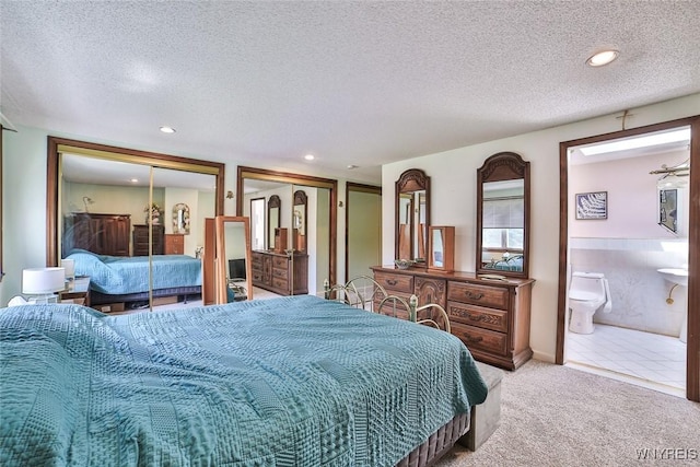 265 Miller Rd, Amherst, NY 14068 - bedroom with multiple closets, light carpet, a textured ceiling, ensuite bath, and recessed lighting