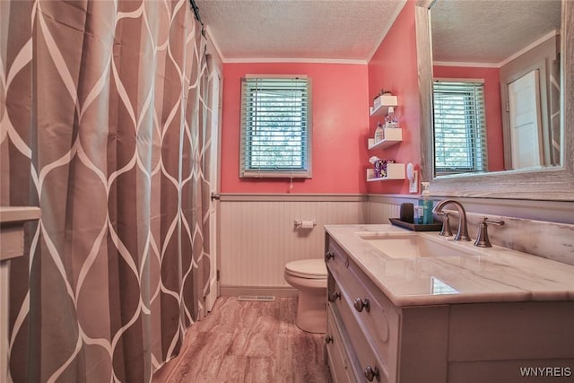 265 Miller Rd, Amherst, NY 14068 - bathroom with crown molding, vanity, wood finished floors, a textured ceiling, and a wainscoted wall