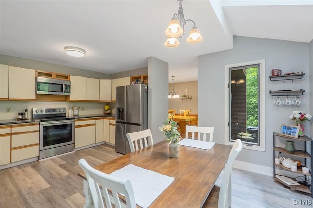 129 Quartz, Camillus, NY 13219 - dining space with a chandelier, light wood finished floors, and vaulted ceiling