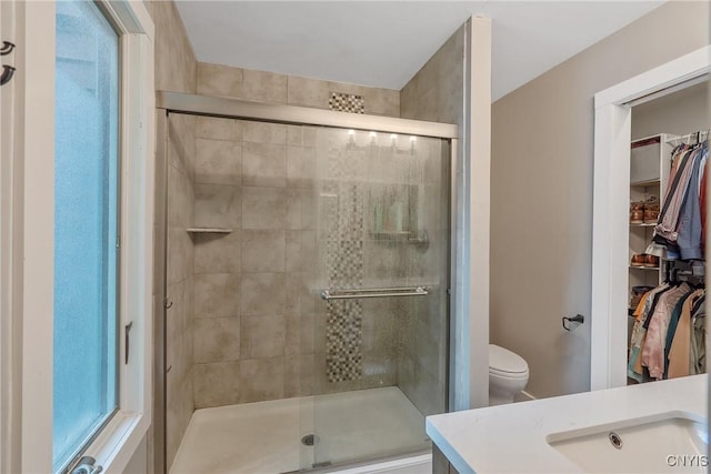 129 Quartz, Camillus, NY 13219 - bathroom featuring a walk in closet, a shower stall, and vanity