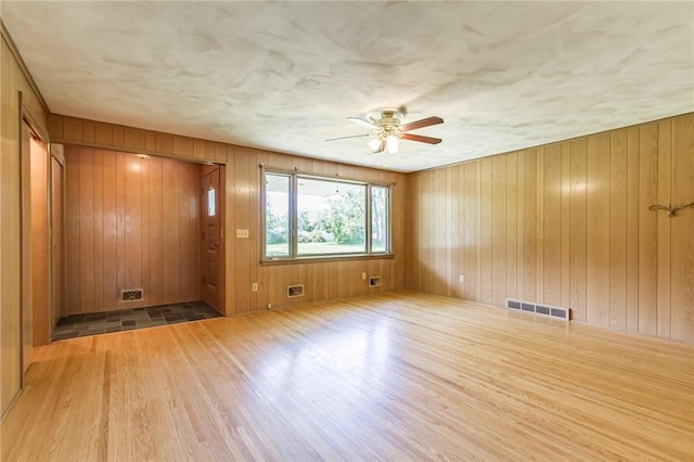 65 Meyerhill Cir E, Irondequoit, NY 14617 - empty room with wood finished floors, a ceiling fan, and wood walls