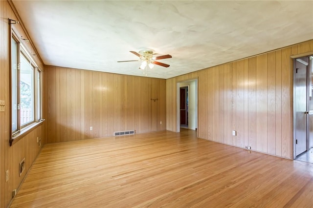 65 Meyerhill Cir E, Irondequoit, NY 14617 - spare room with a ceiling fan, light wood finished floors, and wooden walls