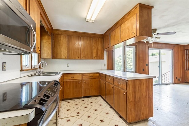 65 Meyerhill Cir E, Irondequoit, NY 14617 - kitchen featuring stainless steel appliances, a peninsula, brown cabinets, and light countertops