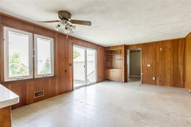 65 Meyerhill Cir E, Irondequoit, NY 14617 - spare room with wood walls and ceiling fan