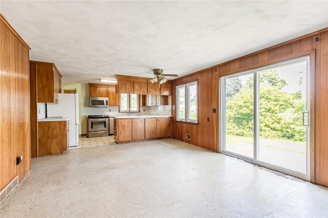 65 Meyerhill Cir E, Irondequoit, NY 14617 - kitchen featuring stainless steel appliances, brown cabinetry, a peninsula, light flooring, and light countertops