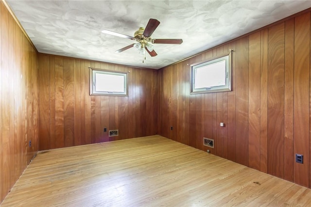 65 Meyerhill Cir E, Irondequoit, NY 14617 - spare room featuring wood finished floors, ceiling fan, and wooden walls
