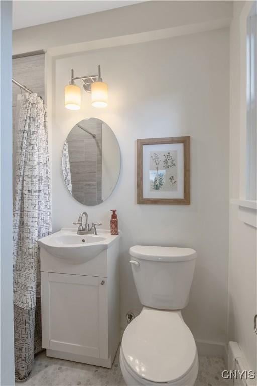 2304 Euclid Ave, Syracuse, NY 13224 - bathroom featuring vanity, baseboard heating, and a shower with curtain