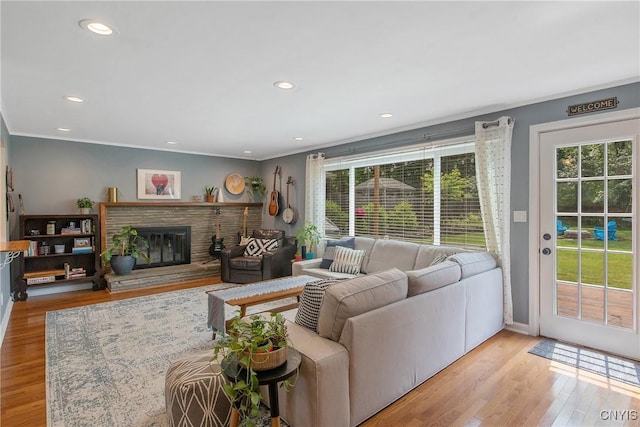 2304 Euclid Ave, Syracuse, NY 13224 - living area with crown molding, wood finished floors, a glass covered fireplace, and recessed lighting