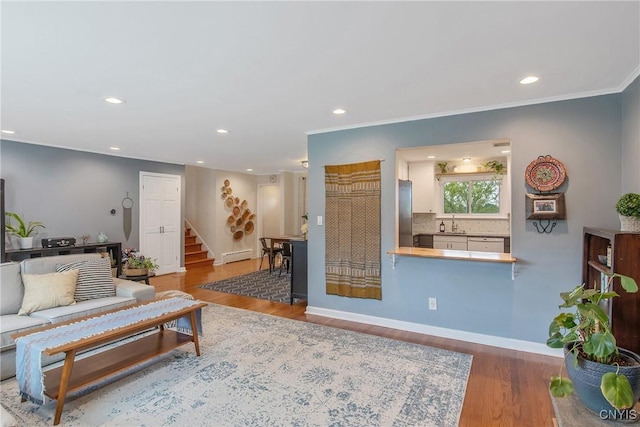 2304 Euclid Ave, Syracuse, NY 13224 - living room with stairs, recessed lighting, wood finished floors, a baseboard radiator, and crown molding