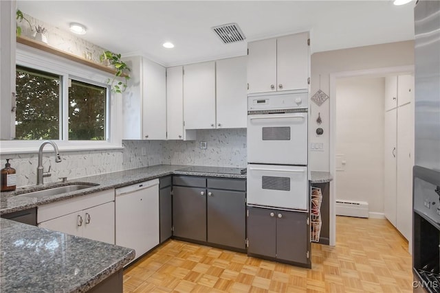 2304 Euclid Ave, Syracuse, NY 13224 - kitchen with white appliances, white cabinets, decorative backsplash, baseboard heating, and recessed lighting