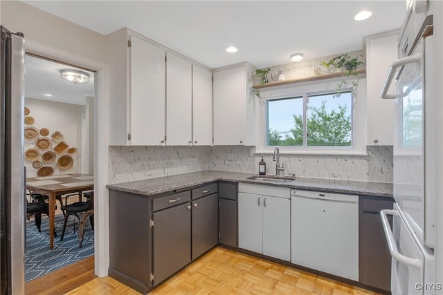 2304 Euclid Ave, Syracuse, NY 13224 - kitchen featuring white dishwasher, tasteful backsplash, refrigerator, white cabinetry, and recessed lighting