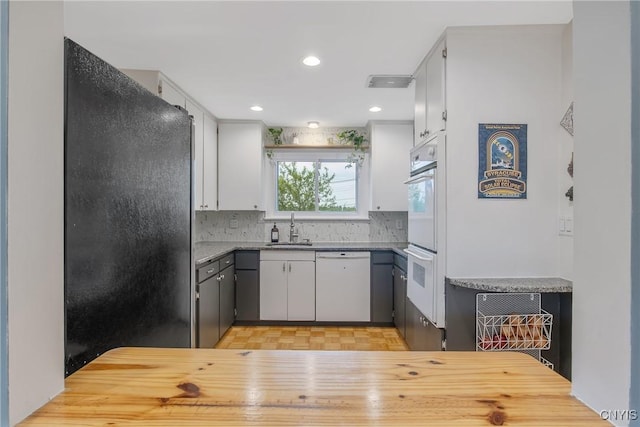2304 Euclid Ave, Syracuse, NY 13224 - kitchen with white appliances, tasteful backsplash, recessed lighting, and white cabinetry