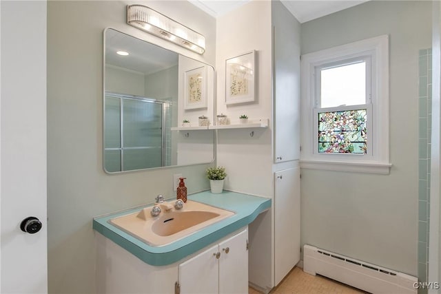 2304 Euclid Ave, Syracuse, NY 13224 - bathroom with a baseboard radiator, a shower stall, vanity, and crown molding
