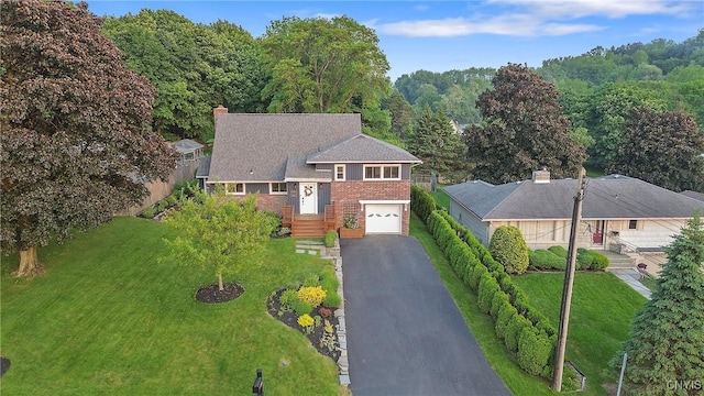 2304 Euclid Ave, Syracuse, NY 13224 - view of front facade featuring a garage, asphalt driveway, a front lawn, and a chimney