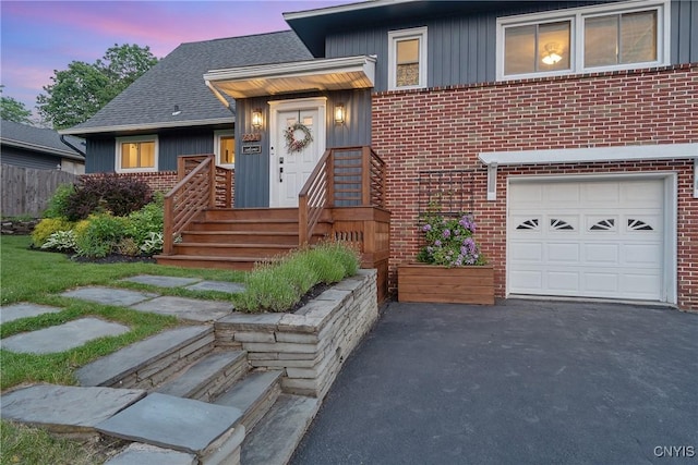 2304 Euclid Ave, Syracuse, NY 13224 - tri-level home with a garage, brick siding, a shingled roof, and board and batten siding