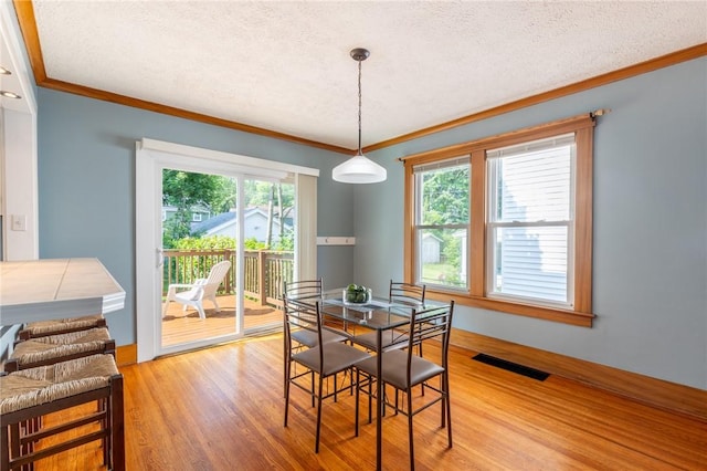 41 Maplehurst Rd, Irondequoit, NY 14617 - dining room with ornamental molding, a textured ceiling, and light wood-type flooring
