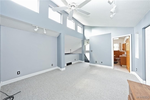 12261 Transit Line Rd, Concord, NY 14141 - unfurnished bedroom with rail lighting, vaulted ceiling, light colored carpet, ensuite bathroom, and ceiling fan