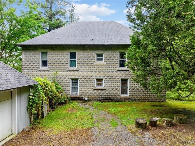 175 S Rondaxe Rd, Webb, NY 13420 - rear view of house featuring roof with shingles