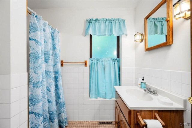 175 S Rondaxe Rd, Webb, NY 13420 - full bathroom featuring tile walls, vanity, a shower with shower curtain, and wainscoting