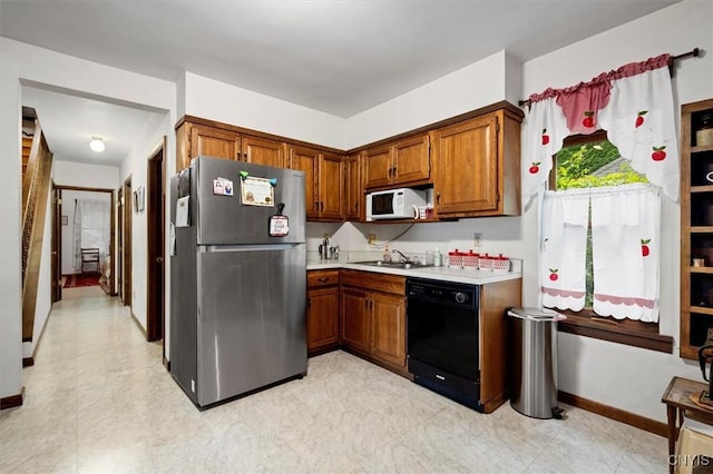 175 S Rondaxe Rd, Webb, NY 13420 - kitchen with freestanding refrigerator, dishwasher, white microwave, light countertops, and brown cabinetry