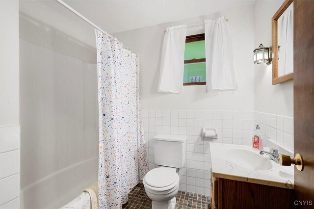175 S Rondaxe Rd, Webb, NY 13420 - full bath with vanity, tile walls, tile patterned flooring, a wainscoted wall, and shower / bath combo