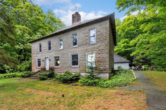 175 S Rondaxe Rd, Webb, NY 13420 - view of front of house featuring a chimney and a front lawn