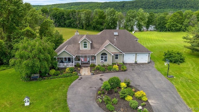 5479 Lake Rd, Tully, NY 13159 - view of front facade featuring a forest view, a front lawn, a porch, and an attached garage