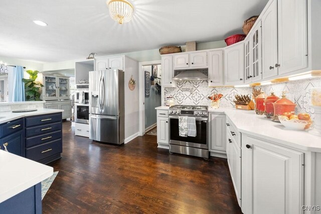 5479 Lake Rd, Tully, NY 13159 - kitchen featuring stainless steel appliances, blue cabinetry, under cabinet range hood, white cabinets, and glass insert cabinets