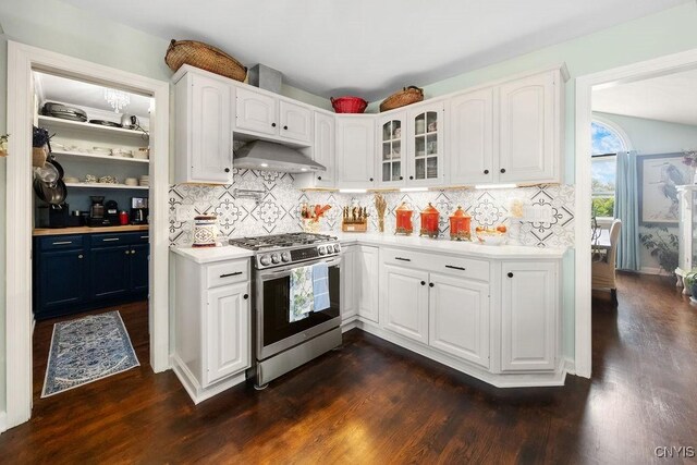5479 Lake Rd, Tully, NY 13159 - kitchen featuring stainless steel gas range oven, exhaust hood, light countertops, glass insert cabinets, and dark wood-style floors