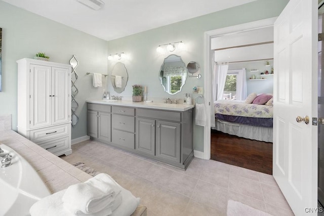 5479 Lake Rd, Tully, NY 13159 - ensuite bathroom with double vanity, a bath, and tile patterned floors
