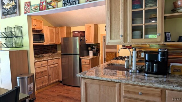 6234 Reservoir Rd, Lebanon, NY 13346 - kitchen with appliances with stainless steel finishes, light wood-type flooring, light brown cabinets, vaulted ceiling, and light stone counters