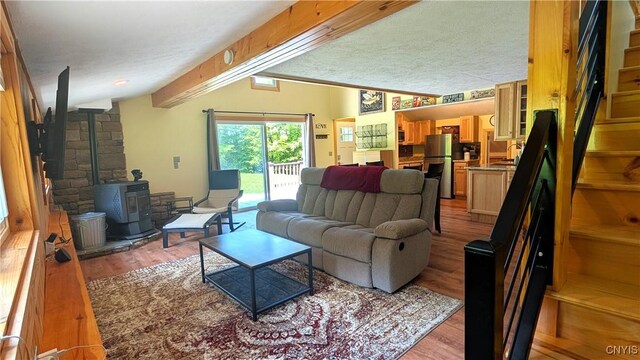 6234 Reservoir Rd, Lebanon, NY 13346 - living area with light wood-style flooring, lofted ceiling, a wood stove, and stairs