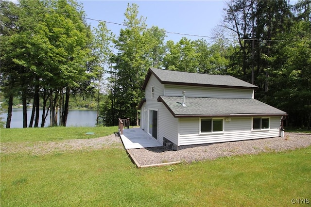 6234 Reservoir Rd, Lebanon, NY 13346 - view of side of home featuring a lawn, a shingled roof, and a water view