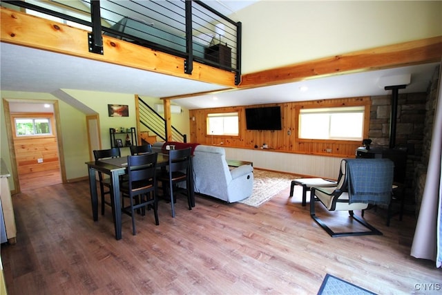 6234 Reservoir Rd, Lebanon, NY 13346 - dining room featuring a wood stove, wood finished floors, stairway, and wood walls