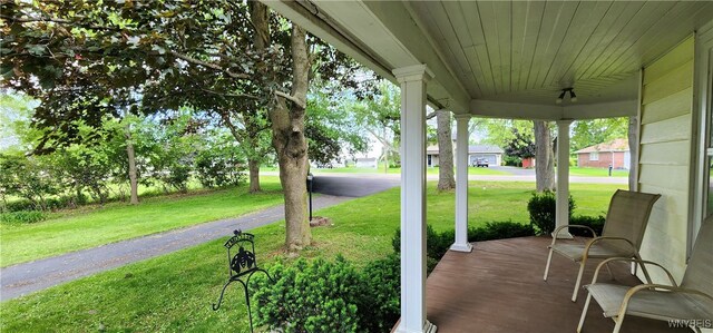 7029 Akron Rd, Lockport Town, NY 14094 - covered porch with a lawn