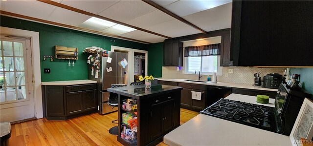 7029 Akron Rd, Lockport Town, NY 14094 - kitchen featuring black appliances, dark cabinets, backsplash, light wood-style flooring, and light countertops