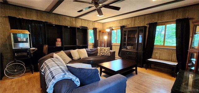 7029 Akron Rd, Lockport Town, NY 14094 - living area with wooden walls, ceiling fan, beam ceiling, and wood finished floors