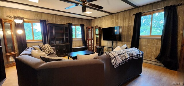 7029 Akron Rd, Lockport Town, NY 14094 - living room featuring light wood-type flooring, a baseboard radiator, wooden walls, healthy amount of natural light, and a ceiling fan