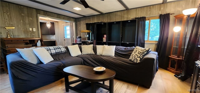 7029 Akron Rd, Lockport Town, NY 14094 - living area featuring wood walls, a ceiling fan, and light wood finished floors