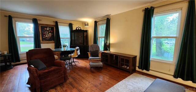 7029 Akron Rd, Lockport Town, NY 14094 - living area featuring plenty of natural light, crown molding, hardwood / wood-style flooring, and baseboard heating