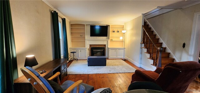 7029 Akron Rd, Lockport Town, NY 14094 - living area featuring hardwood / wood-style floors, stairway, and built in shelves