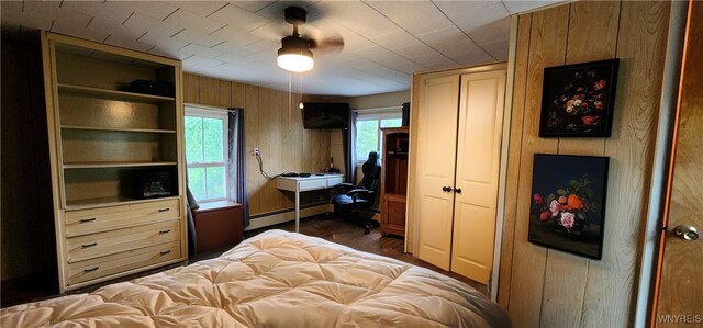 7029 Akron Rd, Lockport Town, NY 14094 - bedroom featuring baseboard heating and wood walls