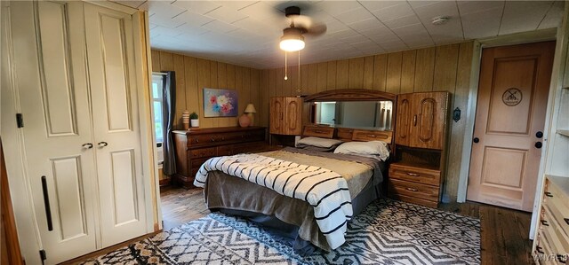 7029 Akron Rd, Lockport Town, NY 14094 - bedroom featuring wood finished floors, wood walls, and ceiling fan