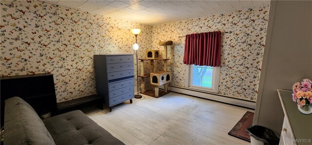 7029 Akron Rd, Lockport Town, NY 14094 - bedroom with wallpapered walls, a baseboard heating unit, and wood finished floors