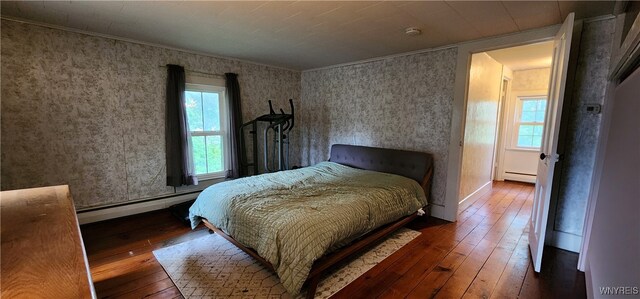 7029 Akron Rd, Lockport Town, NY 14094 - bedroom featuring a baseboard heating unit, hardwood / wood-style floors, wallpapered walls, and crown molding