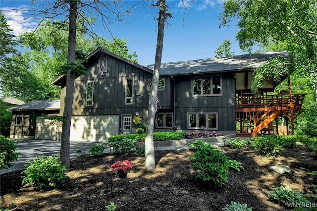 17 Quail, Orchard Park, NY 14127 - rear view of property featuring concrete driveway, stairs, a garage, and a wooden deck